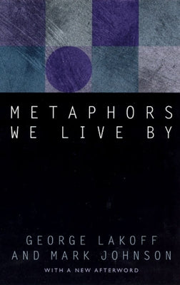 Paperback copy of "Metaphors We Live By" by University of Chicago Press, featuring the book cover with title and author text.