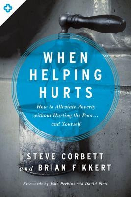 Paperback copy of "When Helping Hurts" by Moody Publishers, featuring the book cover with title and author details.
