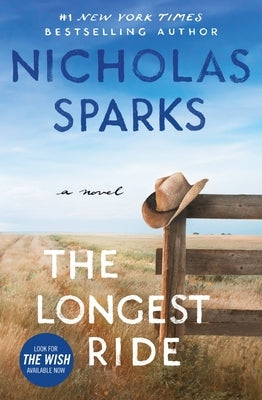 Paperback copy of The Longest Ride novel by Grand Central Publishing featuring a cover with a romantic scene.