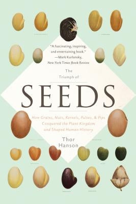 Paperback of "The Triumph of Seeds" by Basic Books, showing the book cover with illustrations of grains, nuts, and seeds.
