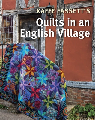 Paperback book titled "Kaffe Fassett's Quilts in an English Village" by Taunton Press, featuring a colorful quilt cover design.