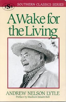 Paperback copy of "A Wake for the Living" by J. S. Sanders and Company, with a cover featuring a dark, atmospheric design.